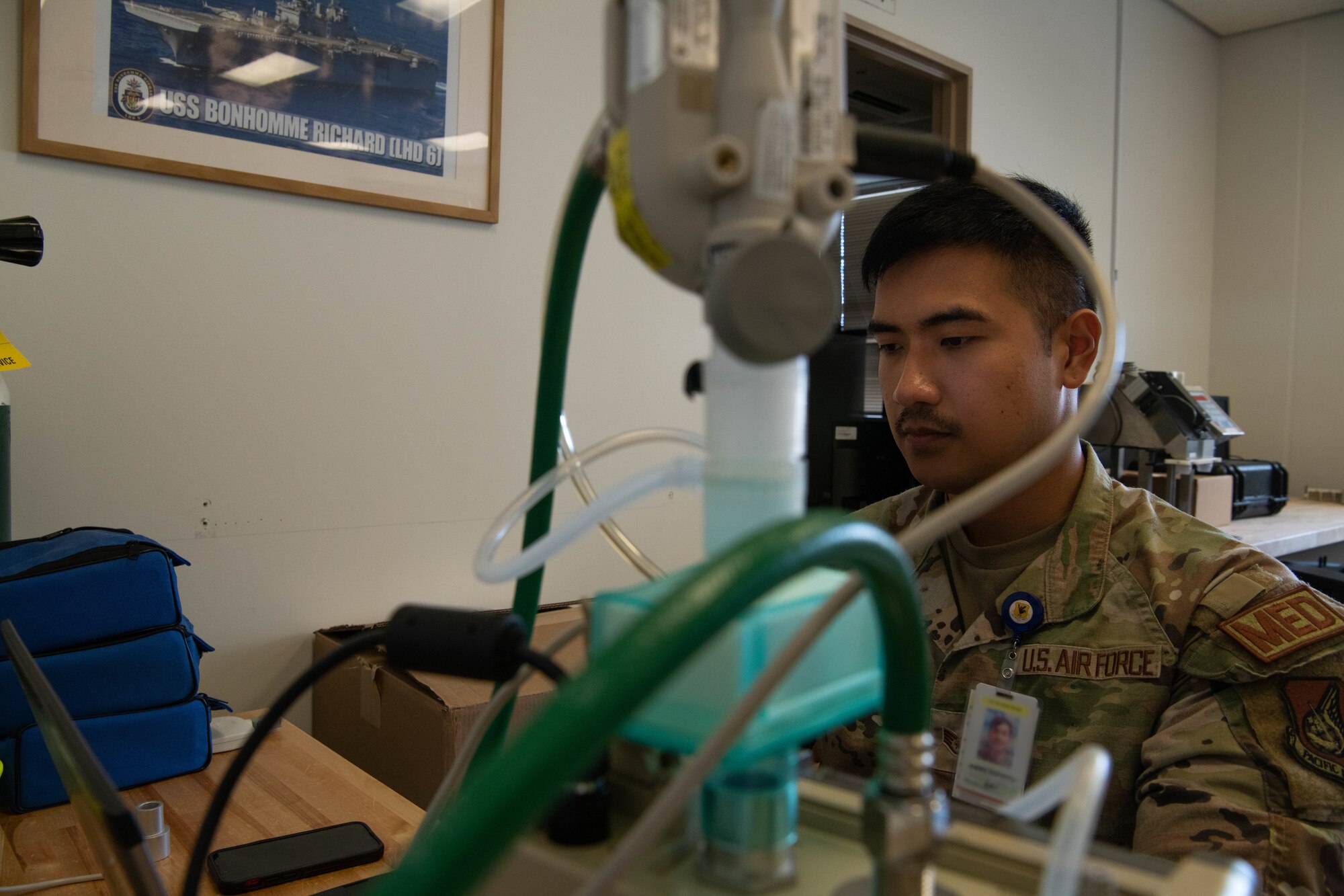 An Airman tests medical equipment.