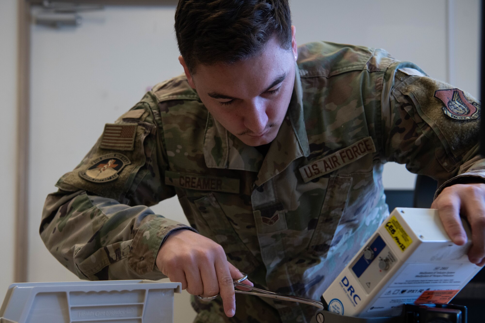 An Airman repairs medical equipment.