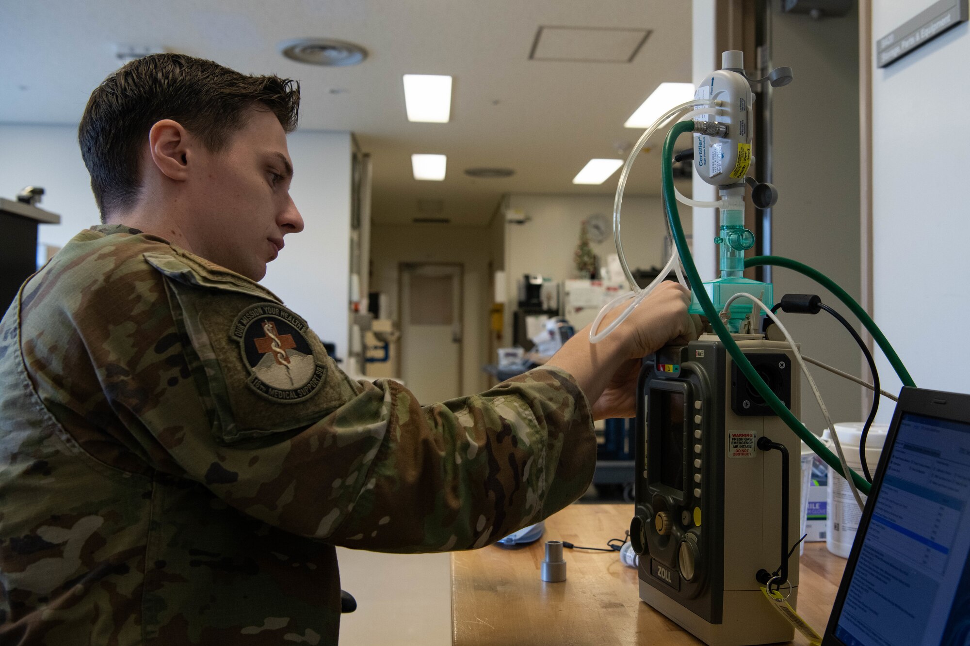 An Airman tests medical equipment.