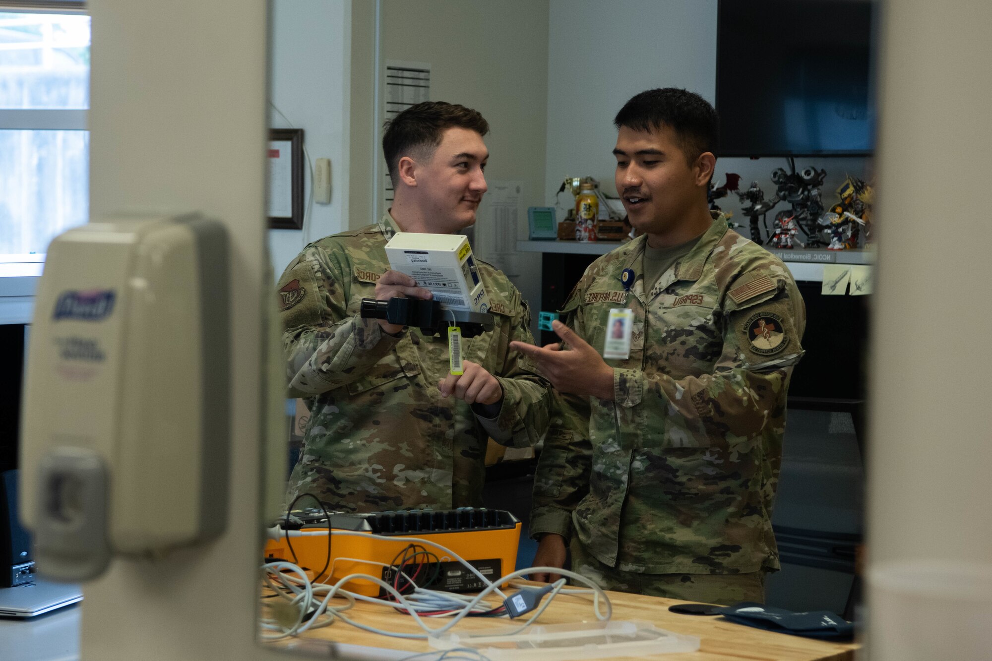 Airmen repair medical equipment.
