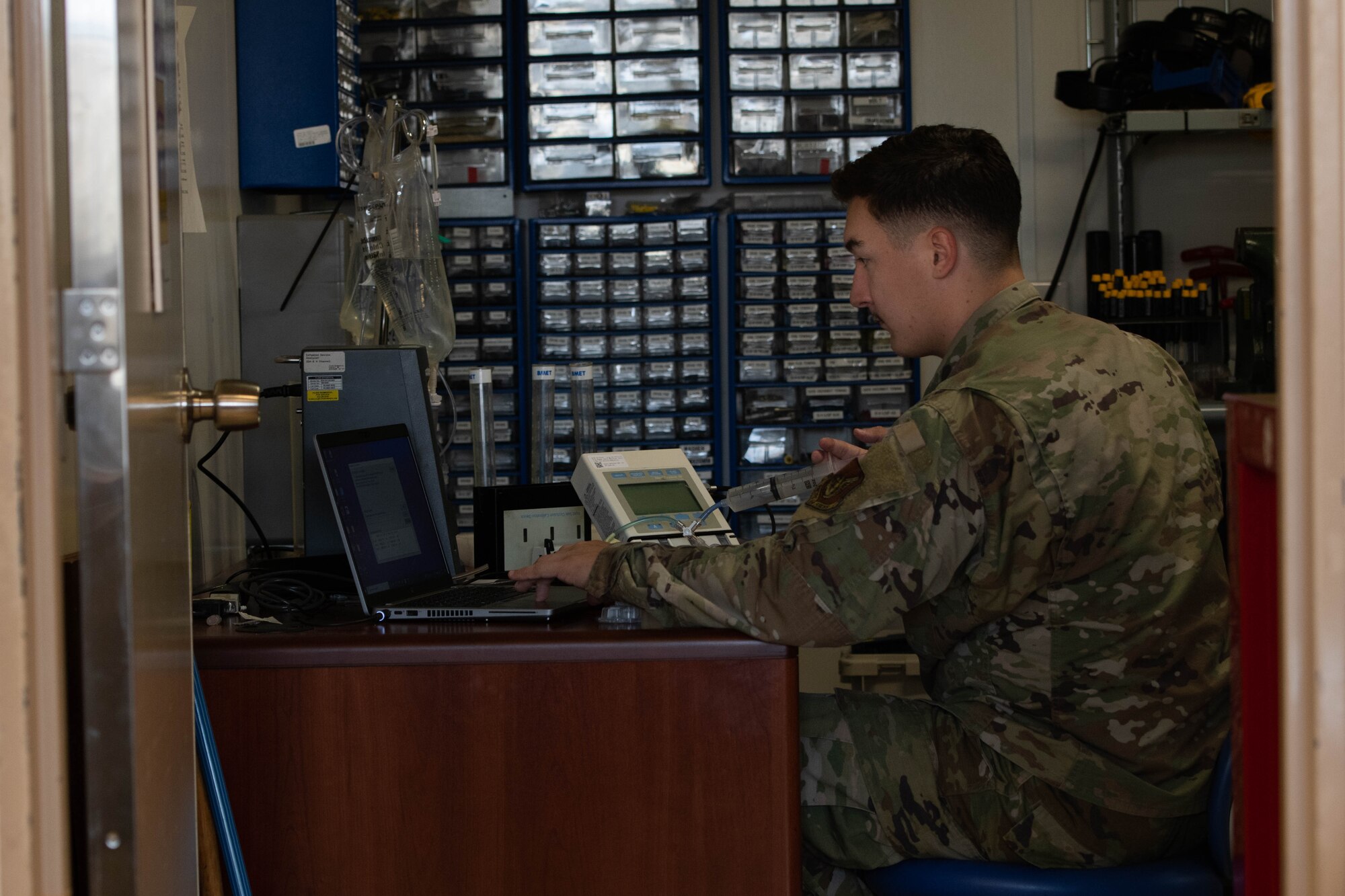 An Airman tests medical equipment.