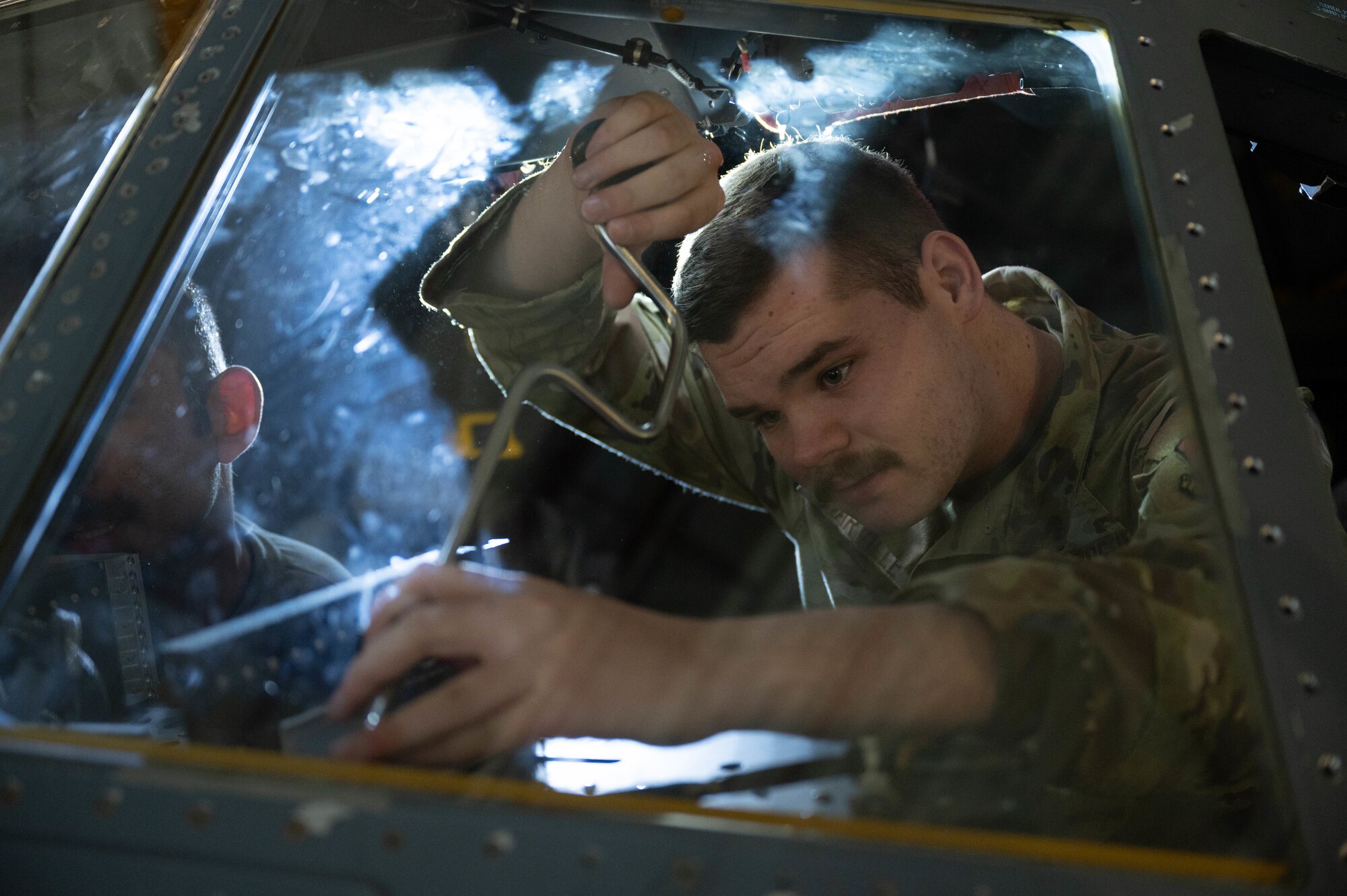 Senior Airman Jamey Harville, 86th Aircraft Maintenance Squadron aerospace maintenance journeyman, fastens a bolt on a C-130J at Ramstein Air Base, Germany, Nov. 7, 2022.