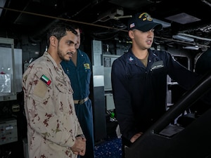 221105-N-UL352-1182 ARABIAN GULF (Nov. 5, 2022) Boatswain’s Mate 3rd Class Jean Castillo, assigned to guided-missile destroyer USS Delbert D. Black (DDG 119), delivers a brief to a member of the United Arab Emirates armed forces during exercise Nautical Defender in the Arabian Gulf, Nov. 5. The multilateral training event involved U.S. Naval Forces Central Command, Royal Saudi Navy’s Eastern Fleet and UK’s Royal Navy, with observers from several regional countries.