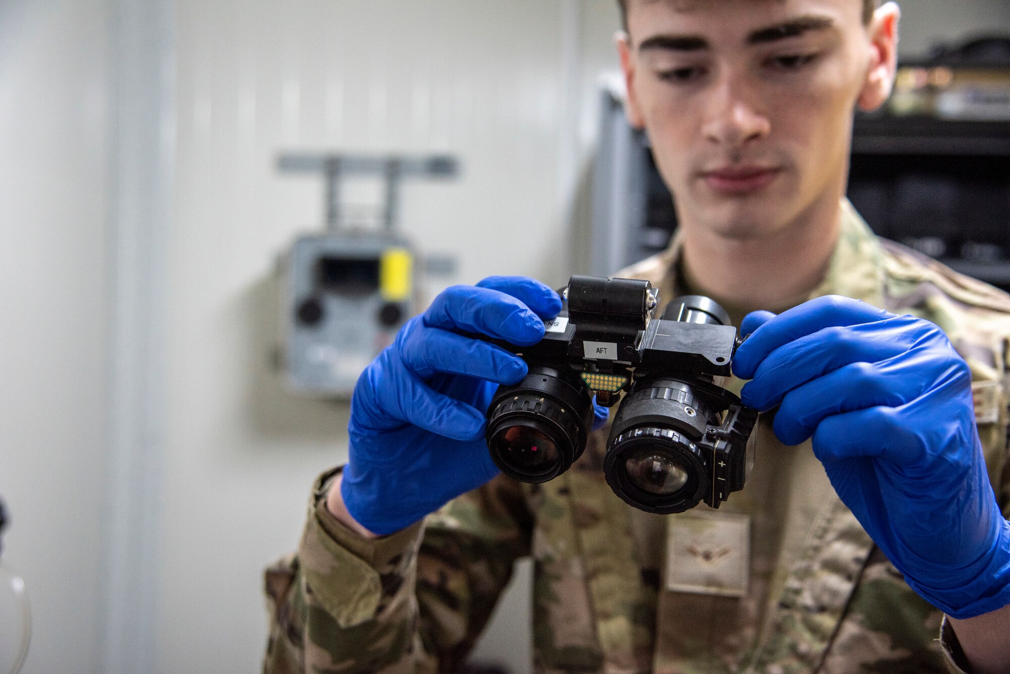 Airman Ryan Adair inspects a pair of night vision goggles at the 332d Air Expeditionary Operations Support Squadron Aircrew Flight Equipment facility at an undisclosed location, Southwest Asia, Oct. 29, 2022. Aircrew Flight Equipment personnel perform maintenance and upkeep for all equipment that pilots and other aircrew need to perform flight missions. (U.S. Air Force photo by: Tech. Sgt. Jim Bentley)
