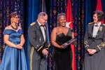 From left, Zanetta Adams, director of the Michigan Veterans Affairs Agency, U.S. Army Maj. Gen. Paul D. Rogers, adjutant general and director of the Michigan Department of Military and Veterans Affairs, presents Chief Warrant Officer 3 Thais Taylor the NAACP Roy Wilkins Renown Service Award, along with CW5 Jessica S Ulrey, at the second annual Michigan Military & Veterans Gala in Lansing, Mich., Nov. 5, 2022.