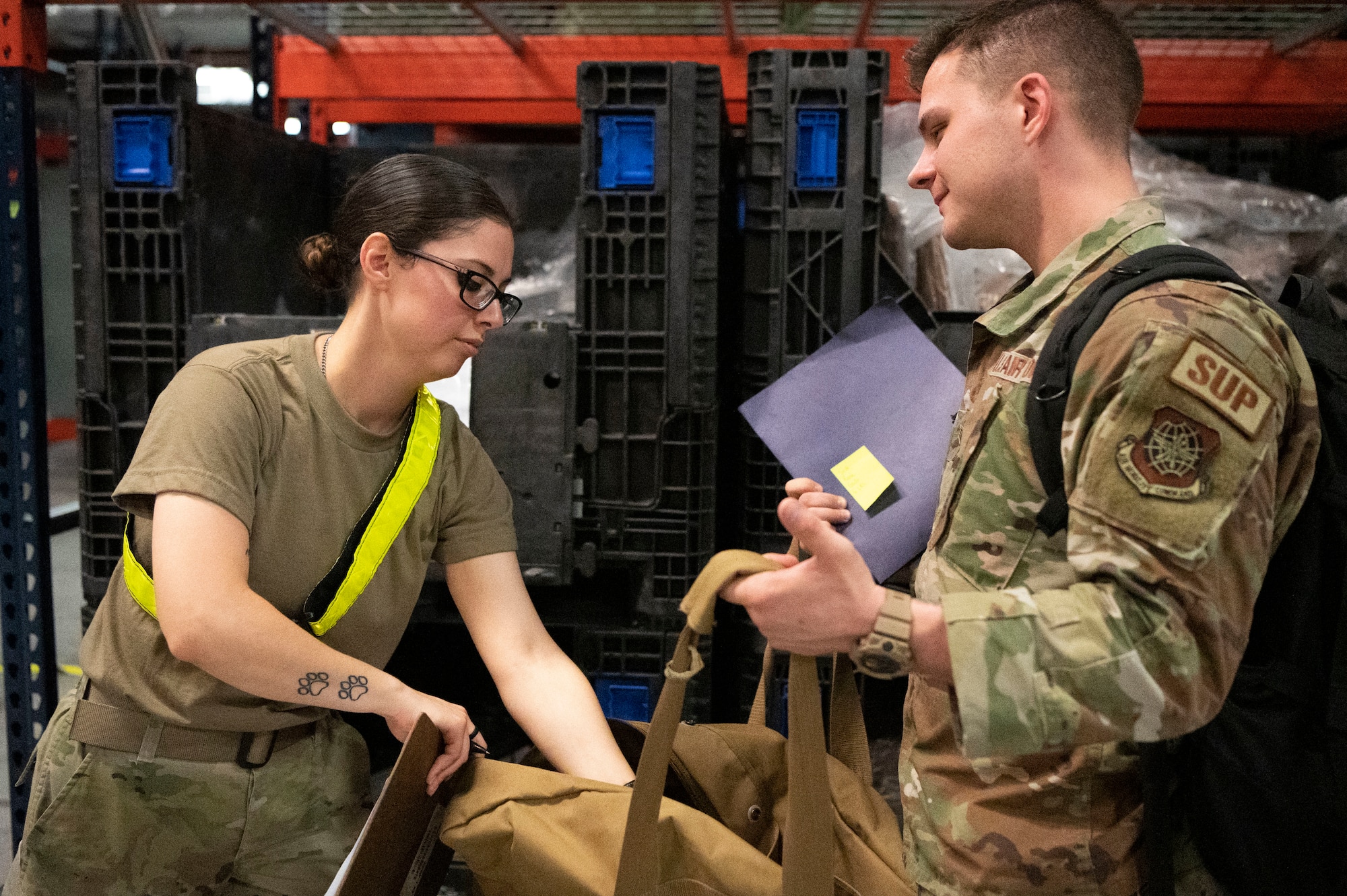 An Airmen with the 6th Air Refueling Wing, participate in a personnel deployment function line, at MacDill Air Force Base, Florida, Nov. 5. 2022. The PDF line ensures personnel are properly equipped with government travel cards, valid identification, dog tags, records of emergency data and other necessary deployment documentation. (U.S. Air Force photo by Airman 1st Class Sterling Sutton)