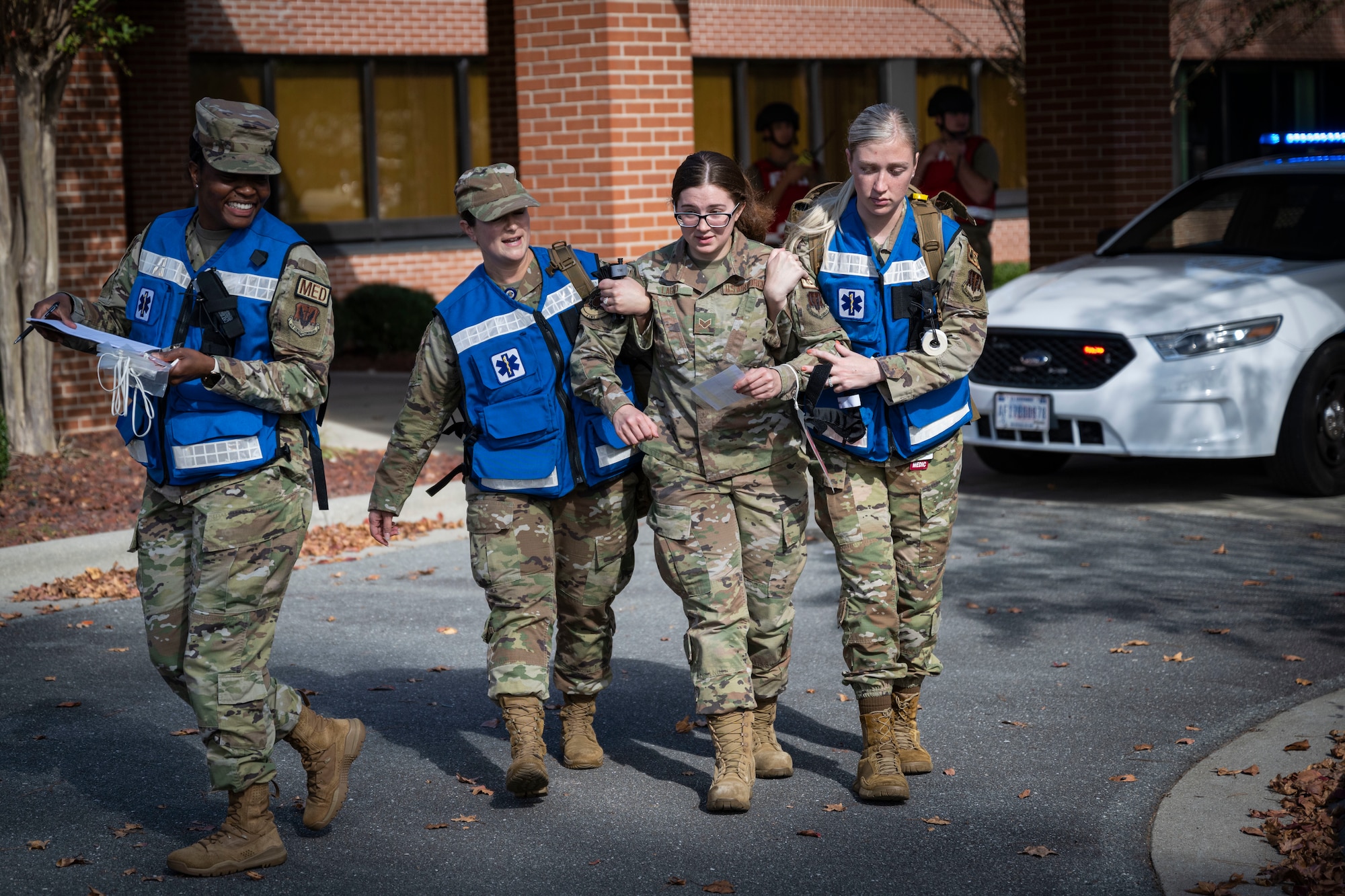 Airmen assigned to the 4th Medical Group assist Senior Airman Makayla Lagro, 4th Component Maintenance Squadron precision measurement equipment laboratory electronics calibration technician and simulated patient, during an active shooter exercise at Seymour Johnson Air Force Base, North Carolina, Nov. 7, 2022. The 4th MDG conducted triage and patient care during the exercise.