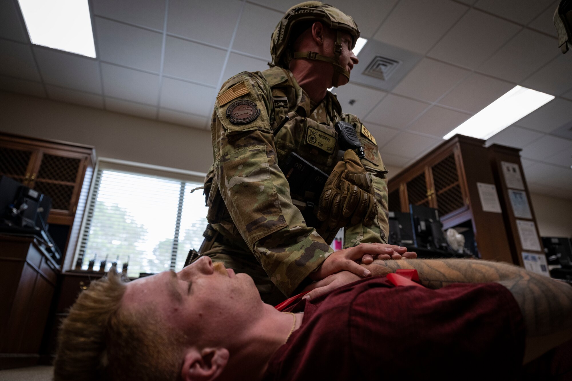 Tech. Sgt. Blaytin Southerly, 4th Security Forces Squadron flight sergeant, treats Senior Airman Dylan Reddish, 4th Logistics Readiness Squadron equipment accountability element technician and simulated victim, during an active-shooter exercise at Seymour Johnson Air Force Base, North Carolina, Nov. 7, 2022. This was the second active-shooter exercise conducted in 2022.