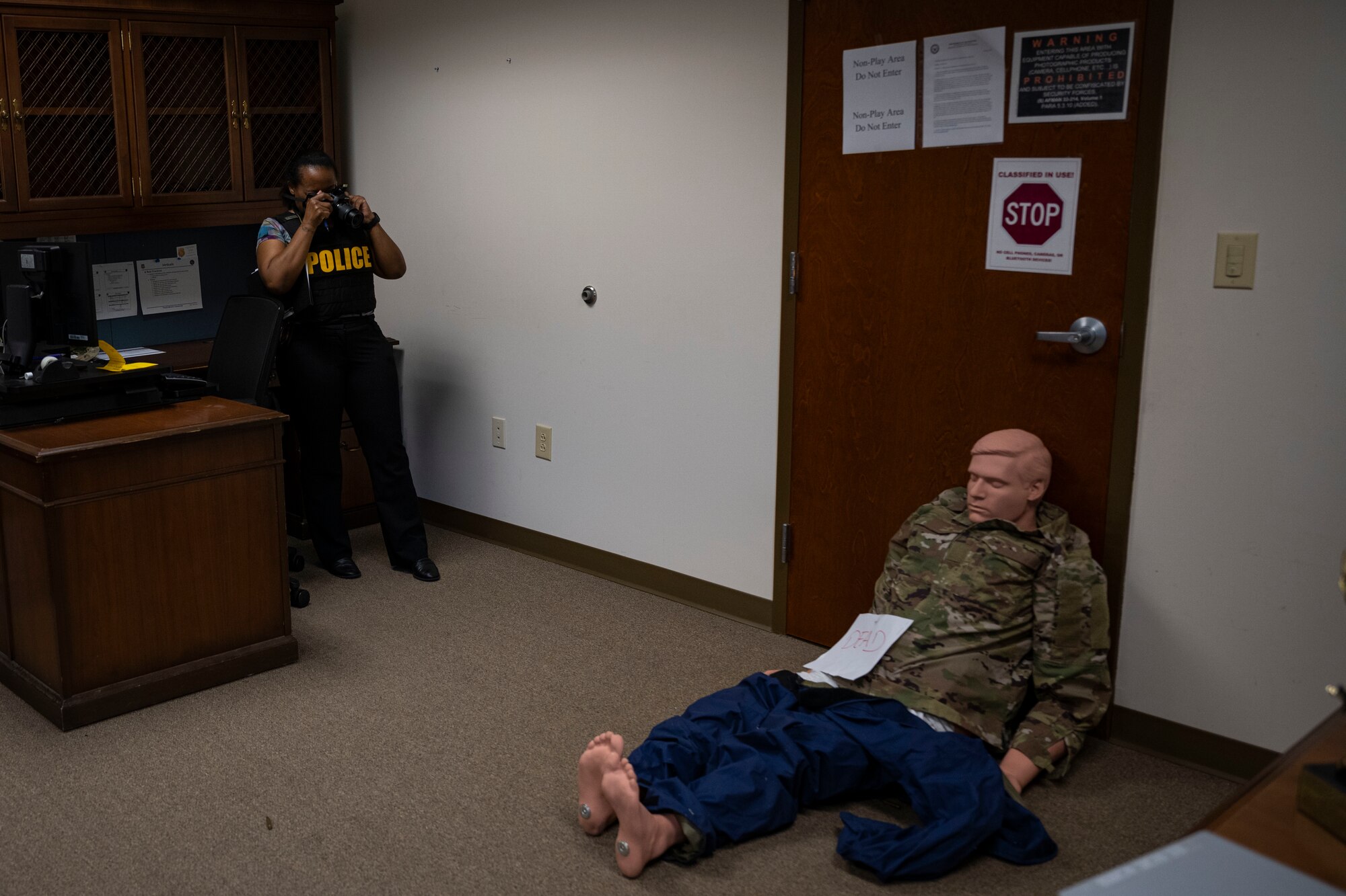 Brandi Dean, Office of Special Investigations Detachment 216 special agent, documents a simulated crime scene during an active shooter exercise at Seymour Johnson Air Force Base, North Carolina, Nov. 7, 2022. The exercise tested Airmen’s ability to respond to real-world situations accordingly.