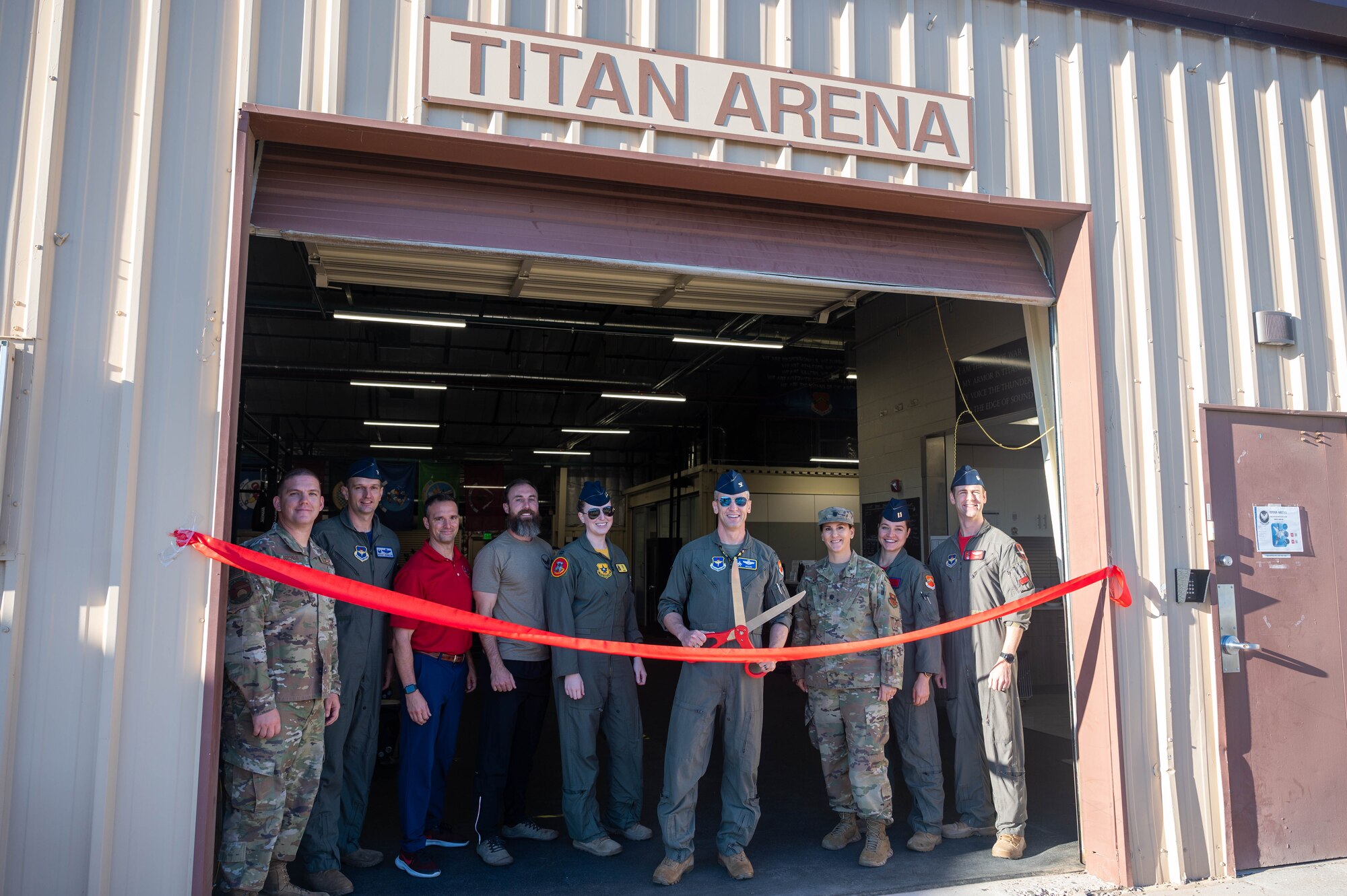 U.S. Air Force Col. Keagan McLeese, 56th Fighter Wing vice commander, prepares to cut the ribbon during the Tactical Integrated Training and Nutrition (TITAN) Arena re-opening event Nov. 4, 2022, at Luke Air Force Base, Arizona.