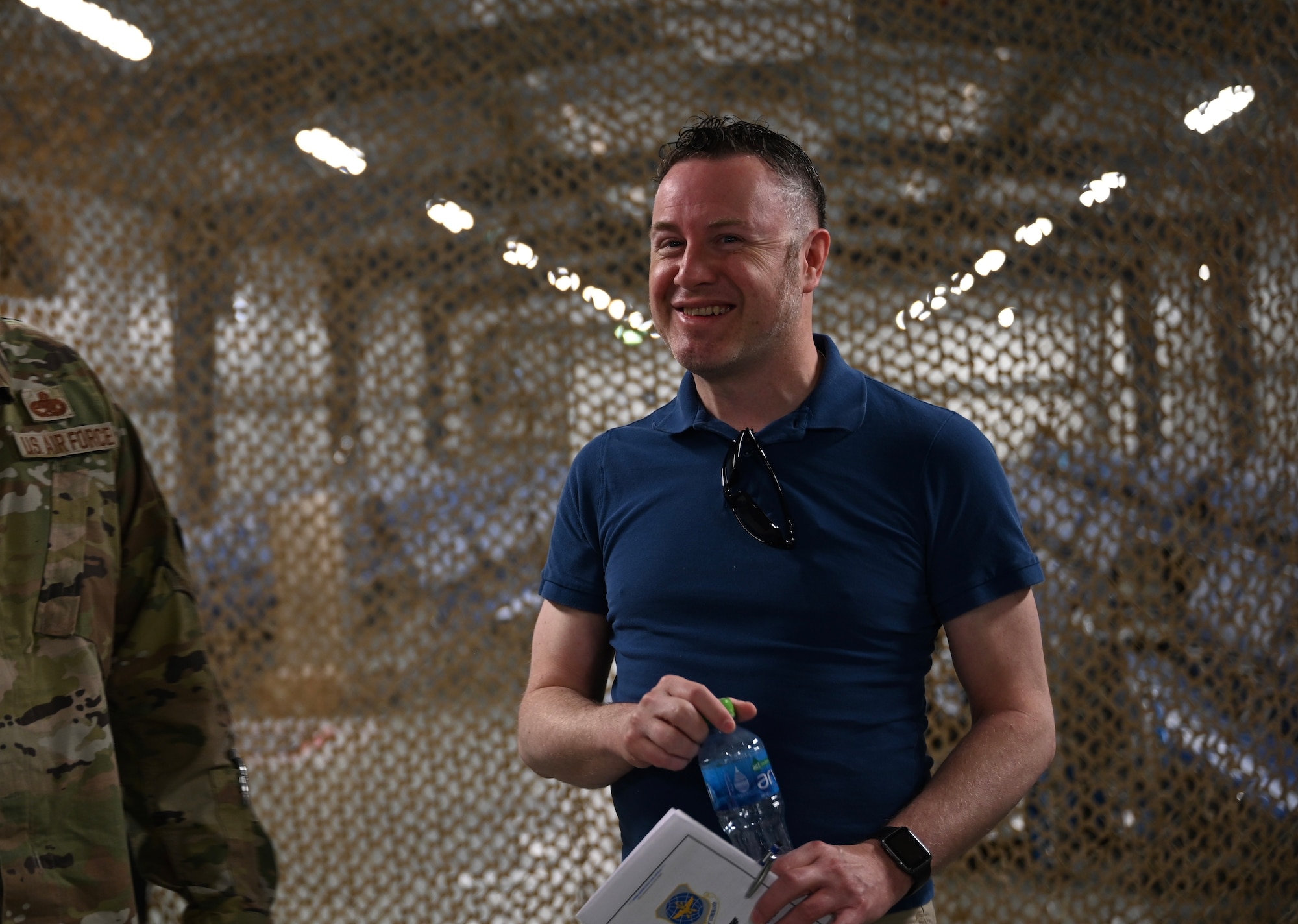 Dr. Andrew Wackerfuss, 521st Air Mobility Operations Wing historian, smiles while talking with Airmen following an inactivation ceremony for the 5th Expeditionary Air Mobility Squadron, Abdullah Al-Mubarak Air Base, Kuwait June 23, 2022.