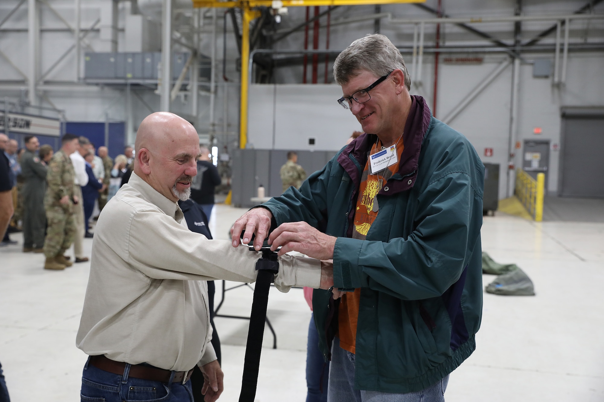 Frederick Brand practices putting on a tourniquet on Tim Kalt's arm during a hand-on demonstration run by the 445th Aerospace Medicine Squadron as part of the 445th Airlift Wing Employer Appreciation Day Nov. 5, 2022. More than 40 employers of 445th AW reservists were treated to breakfast and lunch and had the opportunity to participate in demonstrations and a C-17 Globemaster III Bosslift flight.