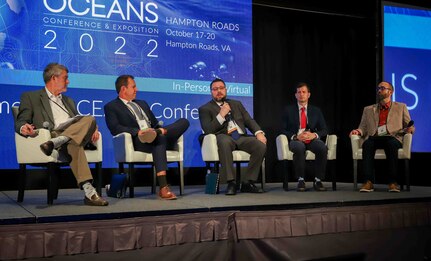 (center) Dr. Josh Weaver, Naval Surface Warfare Center Panama City Division senior scientist for autonomy, addresses his fellow plenary panelists and audience attendees at OCEANS 2022 Hampton Roads, Va., Oct. 18. The conference featured keynote and plenary speakers and nearly 500 technical paper presentations. (left to right) Moderator Jerry Cronin, OpenSeas Technology Innovation Hub at Old Dominion University executive director, and panelists Dr. Eric Terrill, Marine Physical Laboratory director, Dr. Weaver, Dr. Tory Cobb, Office of Naval Research – Artificial Intelligence program officer, and James Fisher, FUGRO Offshore Wind COE – Industry Adoption of Technologies. (U.S. Navy photo by Jeremy Roman)