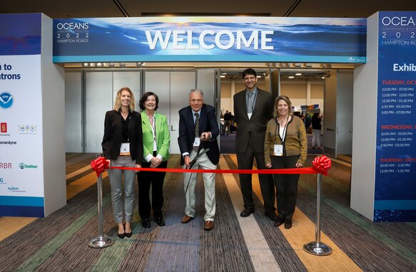 (left to right) Laura Rogers, NASA co-chair, Elizabeth Smith, OCEANS 2022 Exhibits chair and coordinator, Ray Toll, OCEANS 2022 co-chair, Dr. Dan Sternlicht, Naval Surface Warfare Center Panama City Division distinguished scientist for littoral sensing technologies and an OCEANS 2022 general co-chair, and Zdenka Willis, Marine Technology Society president, prepare to officially open the exhibition hall for all attendees at OCEANS 2022 in Virginia Beach, Va., Oct. 18. The hall housed more than 100 exhibition booths from global organizations involved with autonomy, ocean sciences and technological innovations. (U.S. Navy photo by Jeremy Roman)
