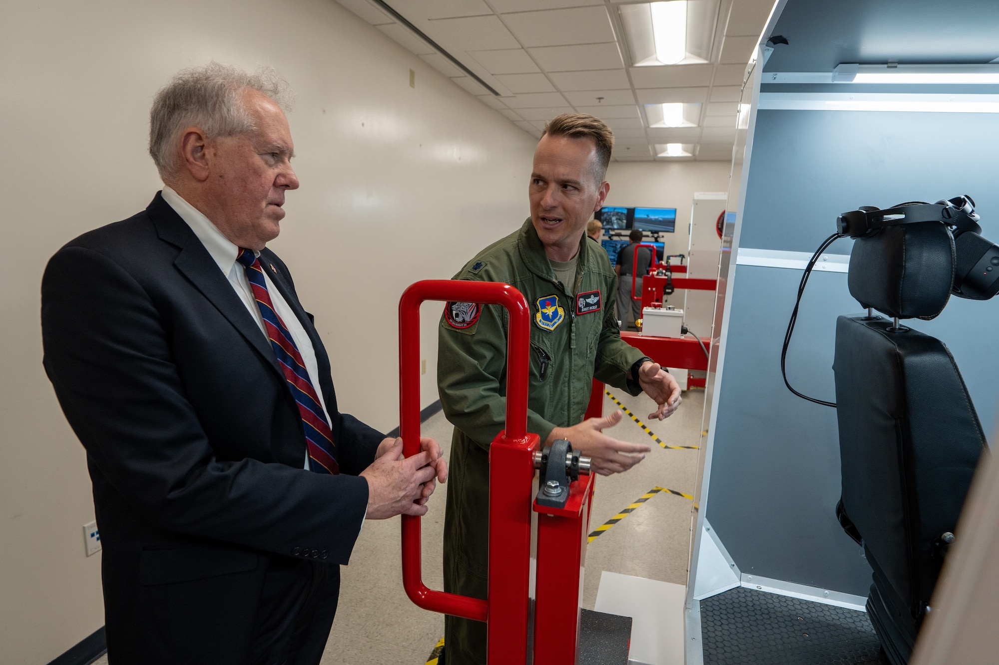 Secretary of the Air Force Frank Kendall receives a briefing on pilot training simulator use.