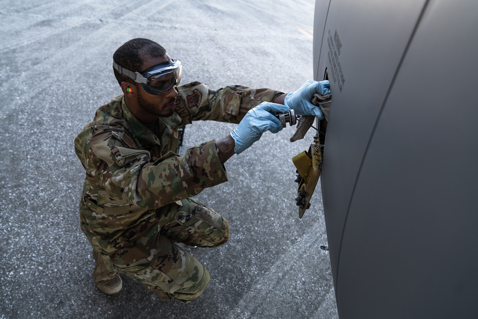 U.S. Air Force Staff Sgt. Korey Hunt, 927th Aircraft Maintenance Squadron crew chief, services engine oil on a KC-135 Stratotanker aircraft assigned to the 6th Air Refueling Wing during a nuclear operational readiness exercise at MacDill Air Force Base, Florida, Nov. 5, 2022. The exercise allowed the 6th ARW to strengthen and refine operations, techniques and procedures in a simulated emergency response. (U.S. Air Force photo by Airman 1st Class Joshua Hastings)