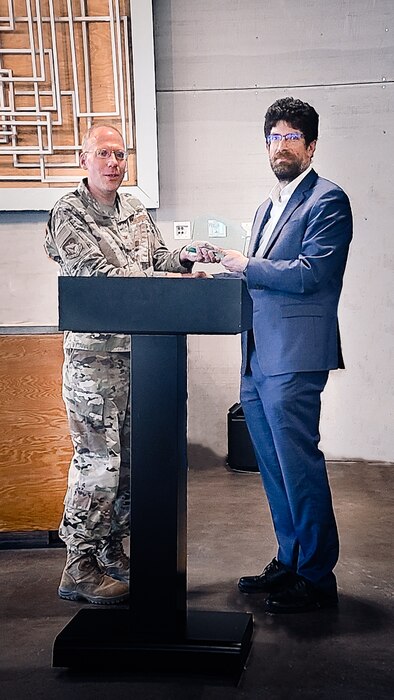 Col. Clark Allred, acting director of the Air Force Research Laboratory, or AFRL, Directed Energy Directorate presents Dr. Andreas Schmitt-Sody, the Directed Energy Directorate assistant chief scientist, an Innovation Award at the technology transfer awards ceremony in Albuquerque, New Mexico, Oct. 20, 2022. AFRL established these awards to recognize and inspire the laboratory’s inventors and collaborators who develop technologies in support of the nation’s defense and whose research promotes the transfer of technology to partners, academia and the private sector. (U.S. Air Force photo / Jeanne Dailey)