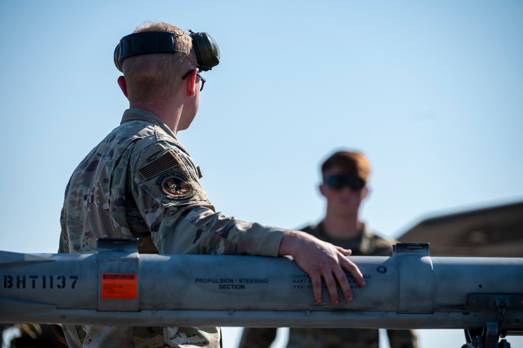 Airman secures a missile to a cart
