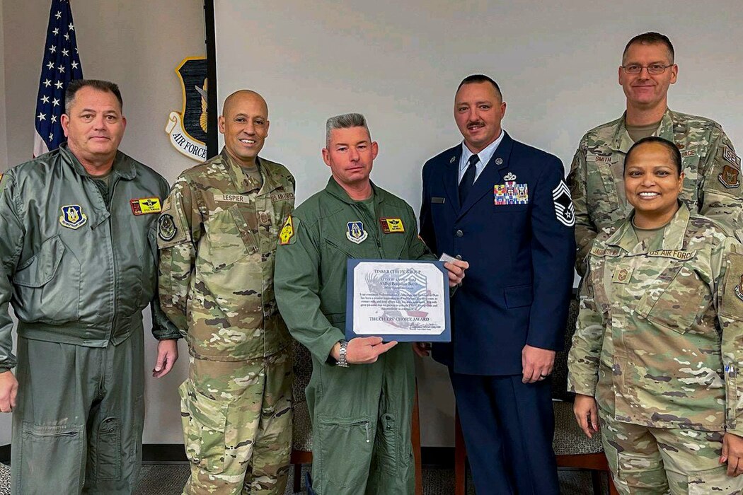 group of airmen holding an award paper