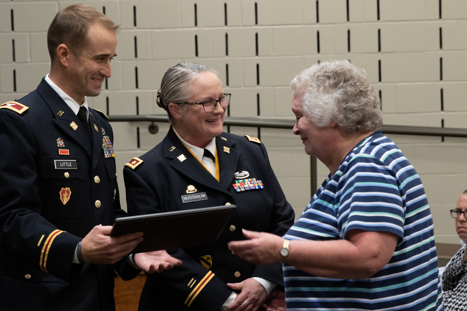 Maj. Elaine Nussbaum and Col. Kevin Little present a certificate of appreciation to Nussbaum’s mother, Therese, during Nussbaum’s Nov. 4 retirement ceremony at Illinois National Guard headquarters on Camp Lincoln, Springfield. Nussbaum, was a key leader in the famed Paris, Ill.-based 1544th Transportation Company and took care of her Soldiers for 22 years. (U.S. Army photo by Spc. Justin Malone, Illinois National Guard)