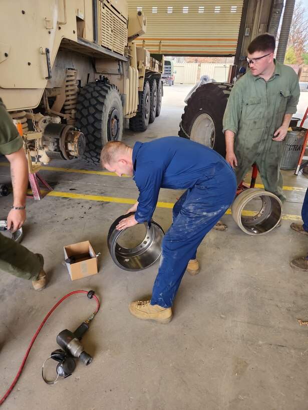 Col Scottie Redden, Detachment CO, turns wrenches with the Motor T Maintenance Marines.