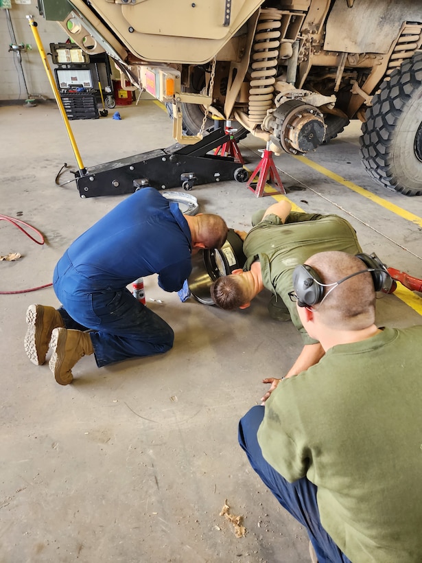 Col Scottie Redden, Detachment CO, turns wrenches with the Motor T Maintenance Marines.