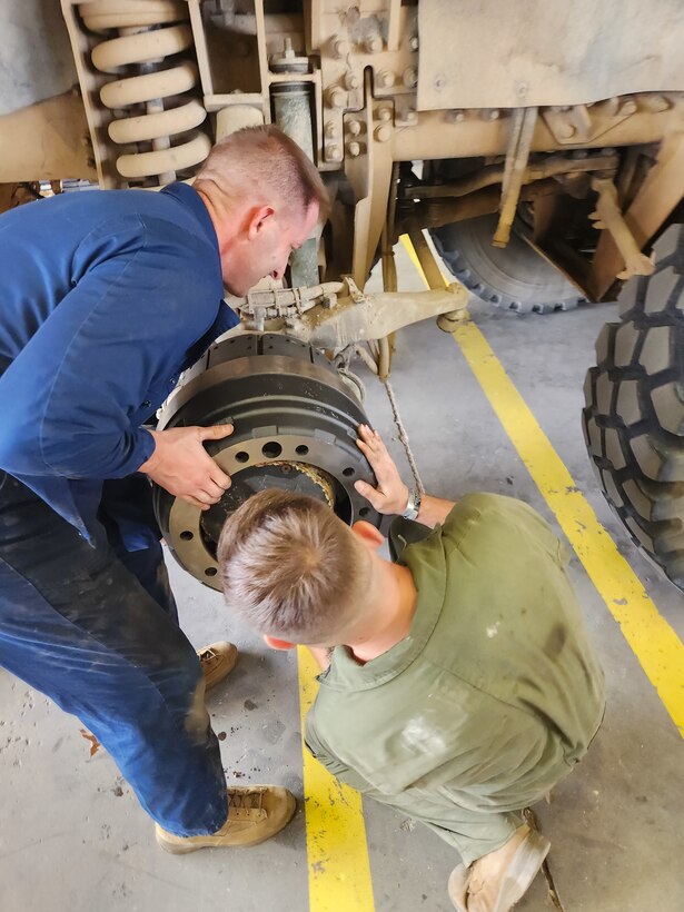 Col Scottie Redden, Detachment CO, turns wrenches with the Motor T Maintenance Marines.