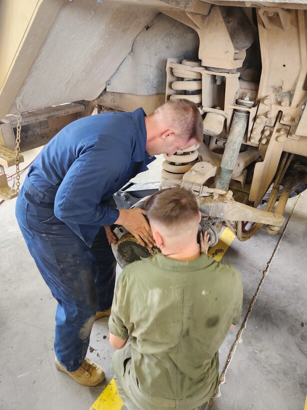 Col Scottie Redden, Detachment CO, turns wrenches with the Motor T Maintenance Marines.