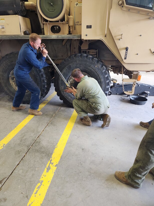 Col Scottie Redden, Detachment CO, turns wrenches with the Motor T Maintenance Marines.