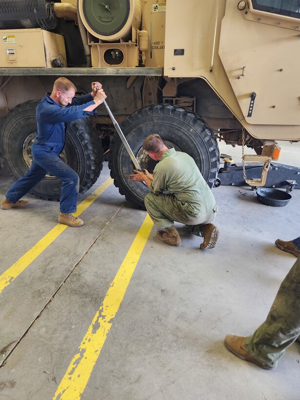 Col Scottie Redden, Detachment CO, turns wrenches with the Motor T Maintenance Marines.