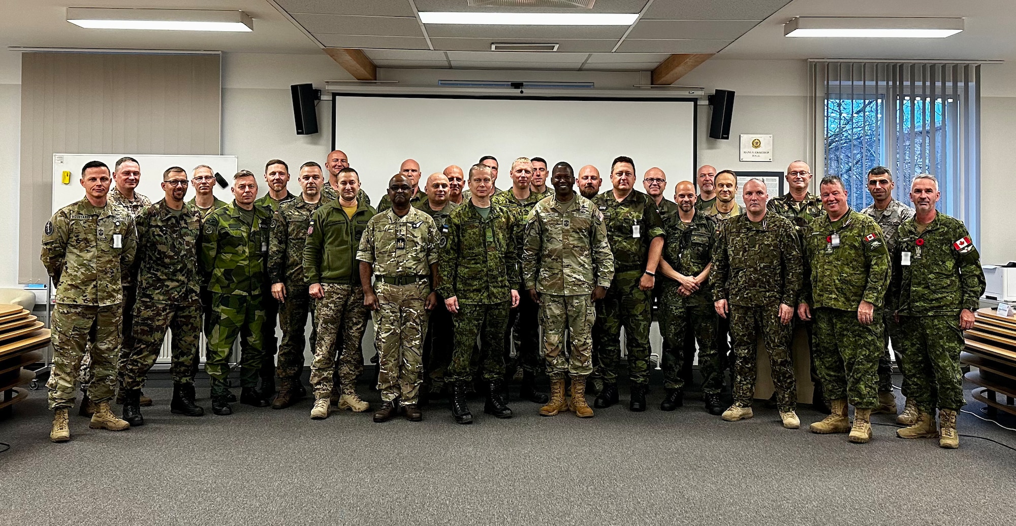 Chief Master Sgt. Jacob Simmons, Senior Enlisted Leader, Space Operations Command, stands with the Baltic Defense College Command Senior Enlisted Leader Course Class of 2022 in Tartu, Estonia on Nov. 4, 2022. While there, Simmons presented a lecture emphasizing space as an element in multidimensional warfare. This course is preparing 24 SELs from 17 NATO nations to elevate their ability and credibility to lead alongside allied forces more effectively through all phases of operations. (Courtesy photo)