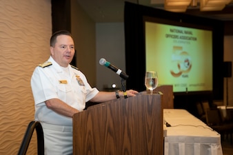 CNP speaks from a podium at a conference