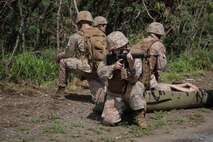 U.S. Marines with Marine Corps Air Station Kaneohe Bay post security while patrolling, Marine Corps Training Area Bellows, Hawaii, Oct. 14, 2022. The purpose of the training was to enhance land navigation skills, and familiarize Marines with proper procedures. (U.S. Marine Corps photo by Lance Cpl. Terry Stennett III)