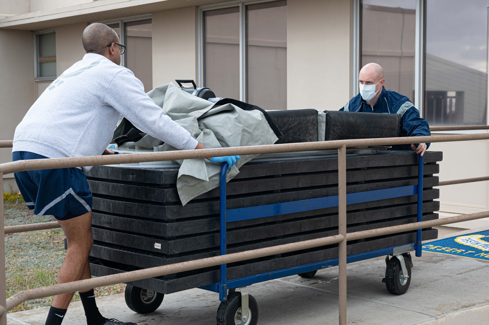 Pictured above are two Airmen pulling a cart.