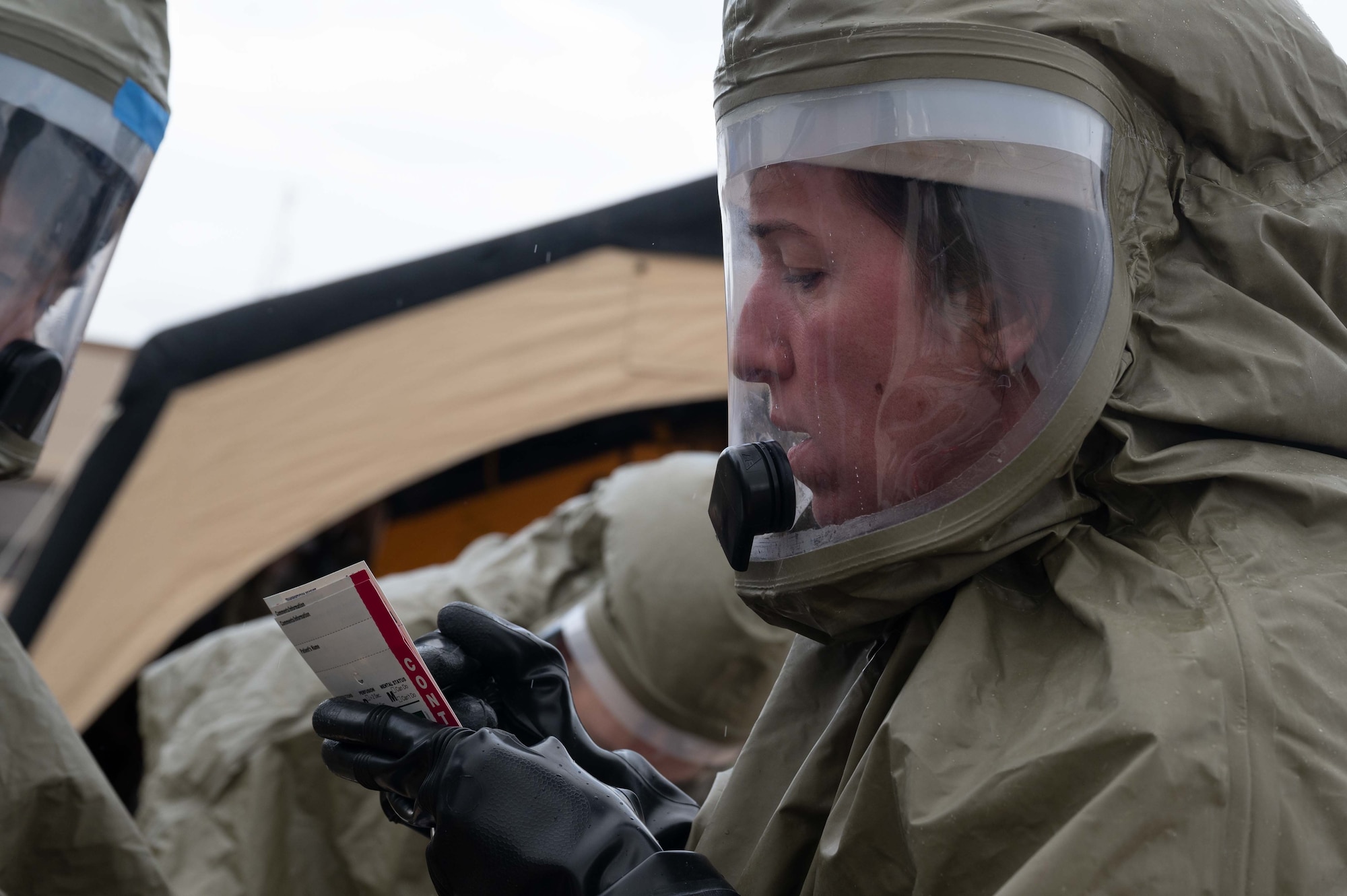 Pictured above is a woman writing on a piece of paper.
