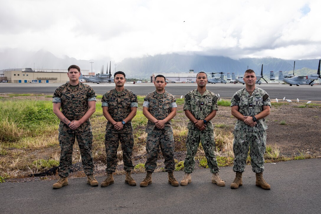 U.S. Marine Corps Sgt. Ethan Slongwhite, left, structural mechanic, Marine Aviation Logistics Squadron 24, Cpl. Brian Fuentes, airframe mechanic, Sgt. Eduardo RamosPalomares, machines shop and additive manufacturing shop supervisor and non-commissioned officer in charge, U.S. Navy Aviation Structural Mechanic Second Class Patrick Boggs, an airframe mechanic, and Aviation Structural Mechanic Second Class Otis Ramey, an airframe mechanic, pose for a photo, Marine Corps Air Station Kaneohe Bay, Marine Corps Base Hawaii, Oct. 5, 2022. Due to their quick reaction, ingenuity, and incorporation of innovative technology, MALS-24 was able to provide an efficient repair using fabricated components. Their actions allowed for an uninterrupted air show and the Trans-Pacific return of the Blue Angels aircraft to the continental U.S. (U.S. Marine Corps photo by Cpl. Samantha Sanchez)