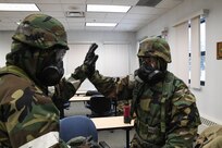 Tech Sgt. Marc Smith and Senior Airman Nicole Colegrove of the 168th Logistics Readiness Squadron give each other a high five during Golden Raven23-1 at Eielson Air Force Base, Alaska, Nov. 4, 2022. Smith and Colegrove were both post-attack reconnaissance team members during the exercise and carried out an observation role for the wing and base leadership. (U.S. Air National Guard photo by Senior Master Sgt. Julie Avey)