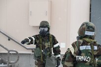 Tech Sgt. Marc Smith of the 168th Logistics Readiness Squadron halts the post-attack reconnaissance team as he observes s suspicious object while conducting a sweep in a simulated chemical, biological, radiological, and nuclear environment during Golden Raven 23-1, Eielson Air Force Base, Alaska, Nov. 4, 2022. The PAR team sweeps assess any damage caused during wartime providing communication to leadership to execute mission-essential tasks. (U.S. Air National Guard photo by Senior Master Sgt. Julie Avey)