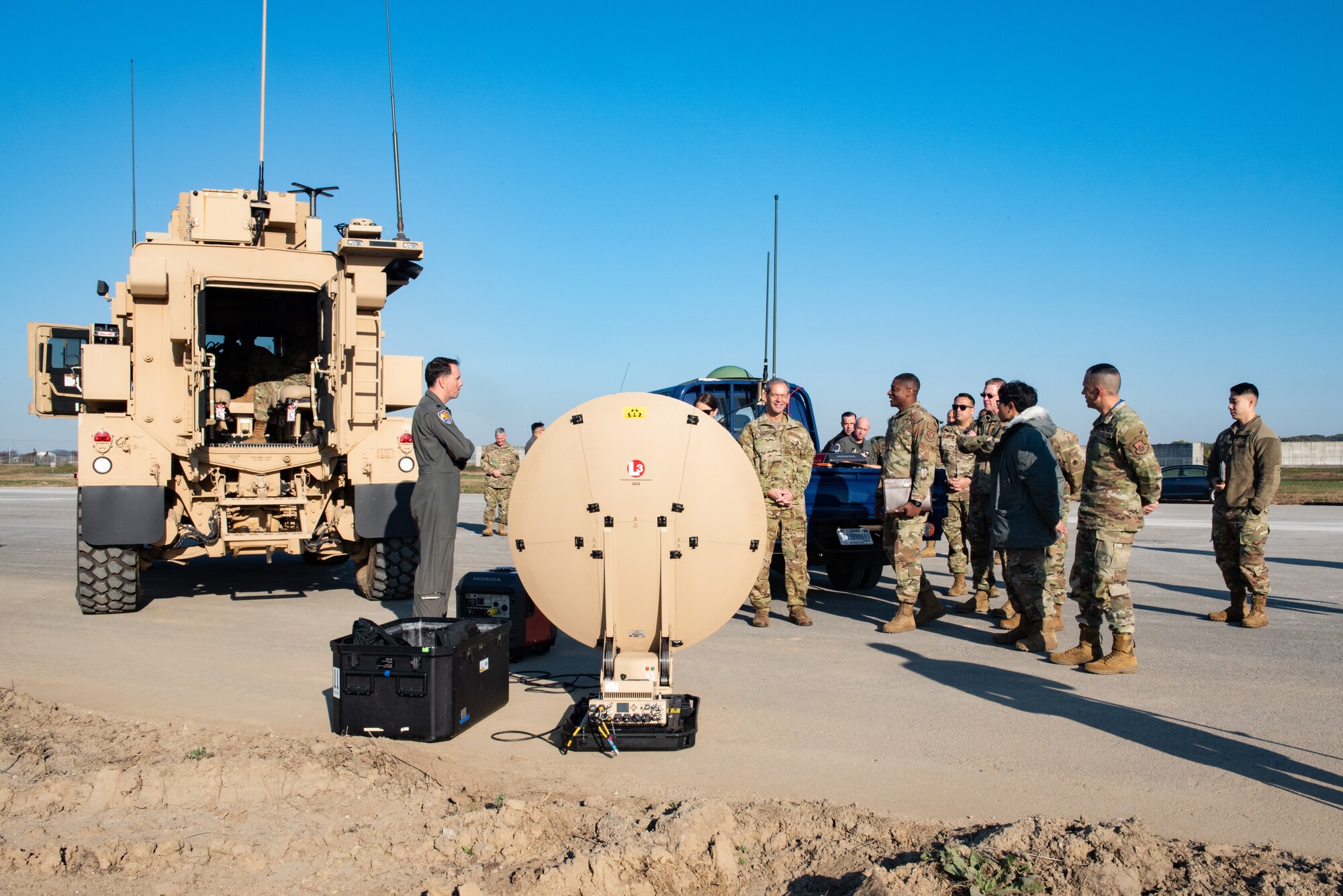 Airmen from the 51st Fighter Wing converse with Gen. Ken Wilsbach, Pacific Air Forces commander, center, about a Communications Flyway Kit (CFK) during a tour at Osan Air Base, Republic of Korea, Nov. 4, 2022.