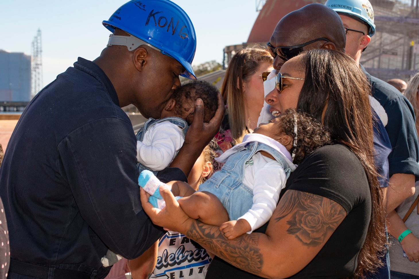 A Sailor stationed aboard the Ohio-class ballistic-missile submarine USS Wyoming (SSBN 742)(Blue) kisses his newborn twin after returning to his homeport of Naval Submarine Base Kings Bay, Georgia, following a routine strategic deterrent patrol that concluded with a tiger cruise. Tiger cruises are an opportunity for Sailors to give friends and family a first-hand experience of life underway aboard a sea-going vessel and experience the ship's day-to-day operations. The base is home to all east coast Ohio-class submarines.