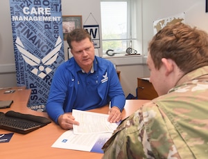 Beau Jones, left, 48th Medical Group Air Force Wounded Warrior Program recovery care coordinator, explains the medical evaluation board process to an Airman at Royal Air Force Lakenheath, England, Nov. 7, 2022. Jones is a retired senior master sergeant with 26 years active-duty service, and former first sergeant for seven squadrons during his 10 years stationed at RAF Mildenhall. He now uses the experience, skills and knowledge he gained in the military and as a first sergeant to help Airmen facing difficult challenges. (U.S. Air Force photo by Karen Abeyasekere)