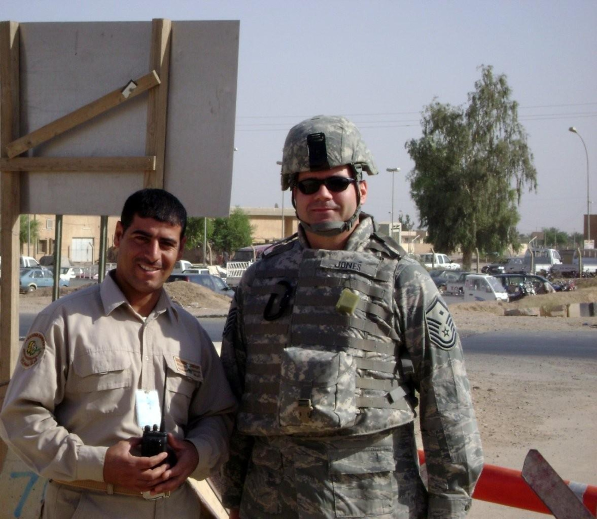 U.S. Air Force then-Master Sgt. Beau Jones, right, then-332nd Security Forces Group first sergeant, poses for a photo with Abdul, an Iraqi security guard, during a deployment to Iraq in August 2009. Abdul was one of around 500 local guards who were the first point of contact for military and locals visiting Balad, helping to protect the base. They were responsible for screening the 1,500 locals who worked on base prior to entry. Jones was visiting the posts where U.S. security forces trained local guards on security procedures. (Courtesy photo)