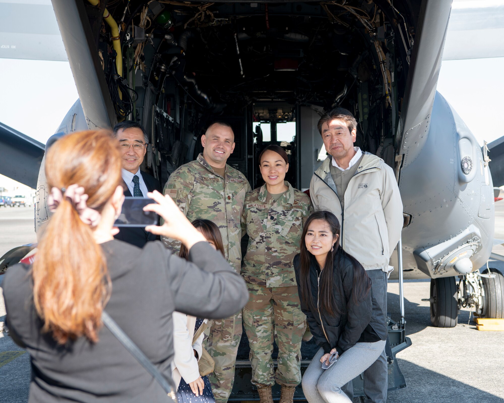 Maj. Nathan Malatesta, 353rd Special Operations Wing detachment 1 commander, left, and Lt. Col. Jennifer Malatesta, 374th Mission Support Group deputy commander, right, pose for a photo with members of Akishima-Yokota Friendship Club during a base immersion tour hosted by the 374th MSG at Yokota Air Base, Japan, Nov. 4, 2022.