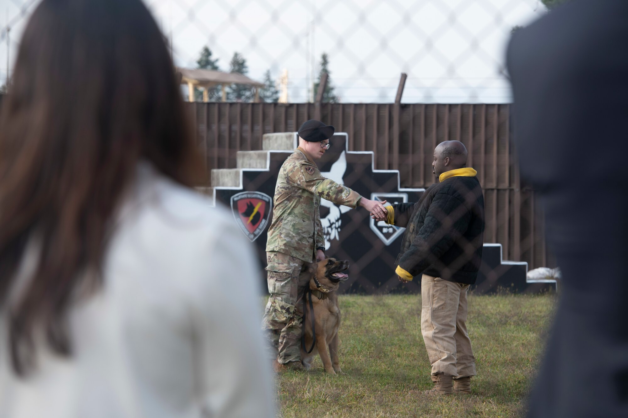 Airmen from the 374th Security Forces Squadron military working dog section perform a demonstration for members of the Akishima-Yokota Friendship Club during a base immersion tour hosted by the 374th Mission Support Group at Yokota Air Base, Japan, Nov. 4, 2022.