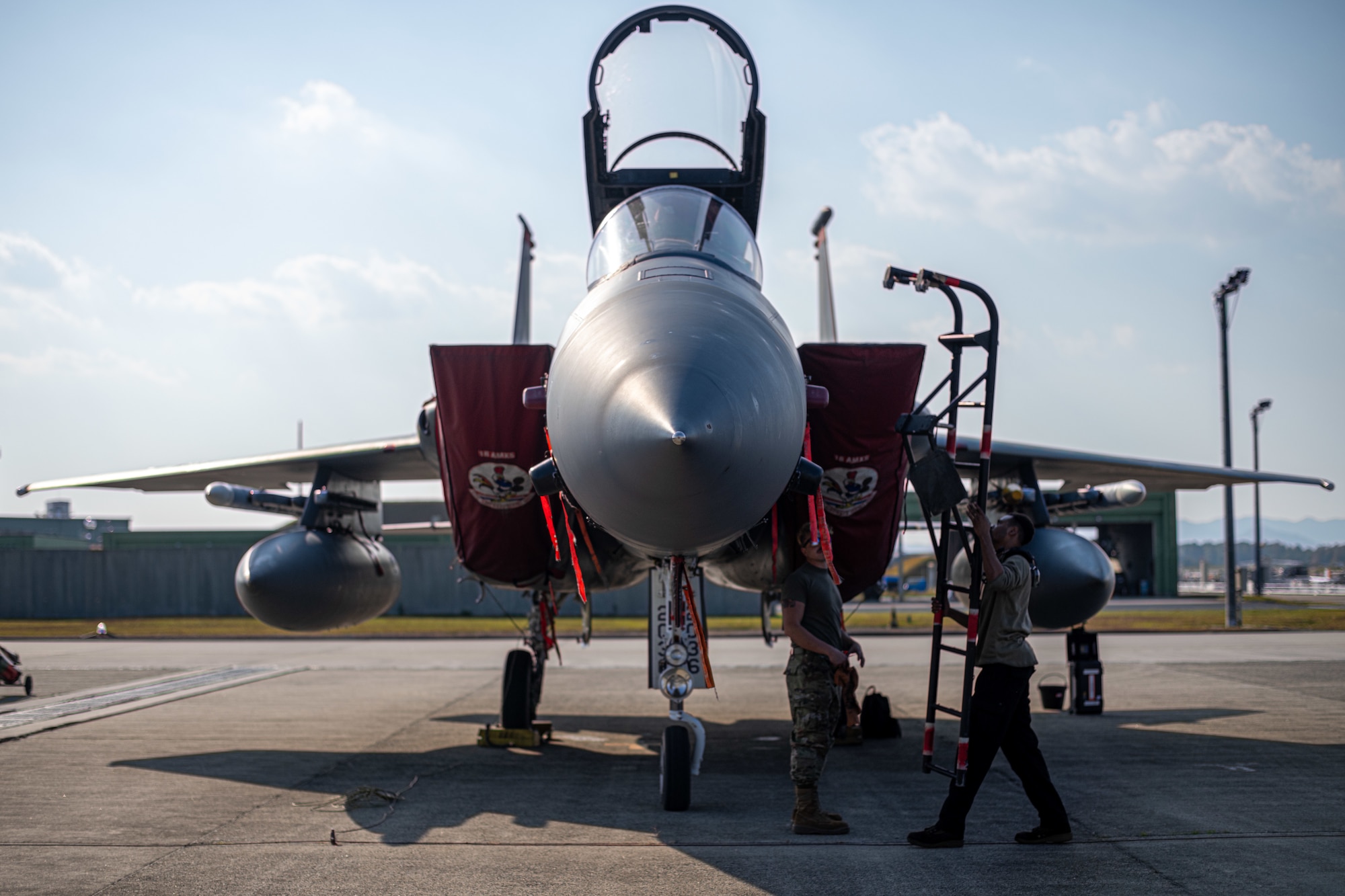 Airmen check a plane.