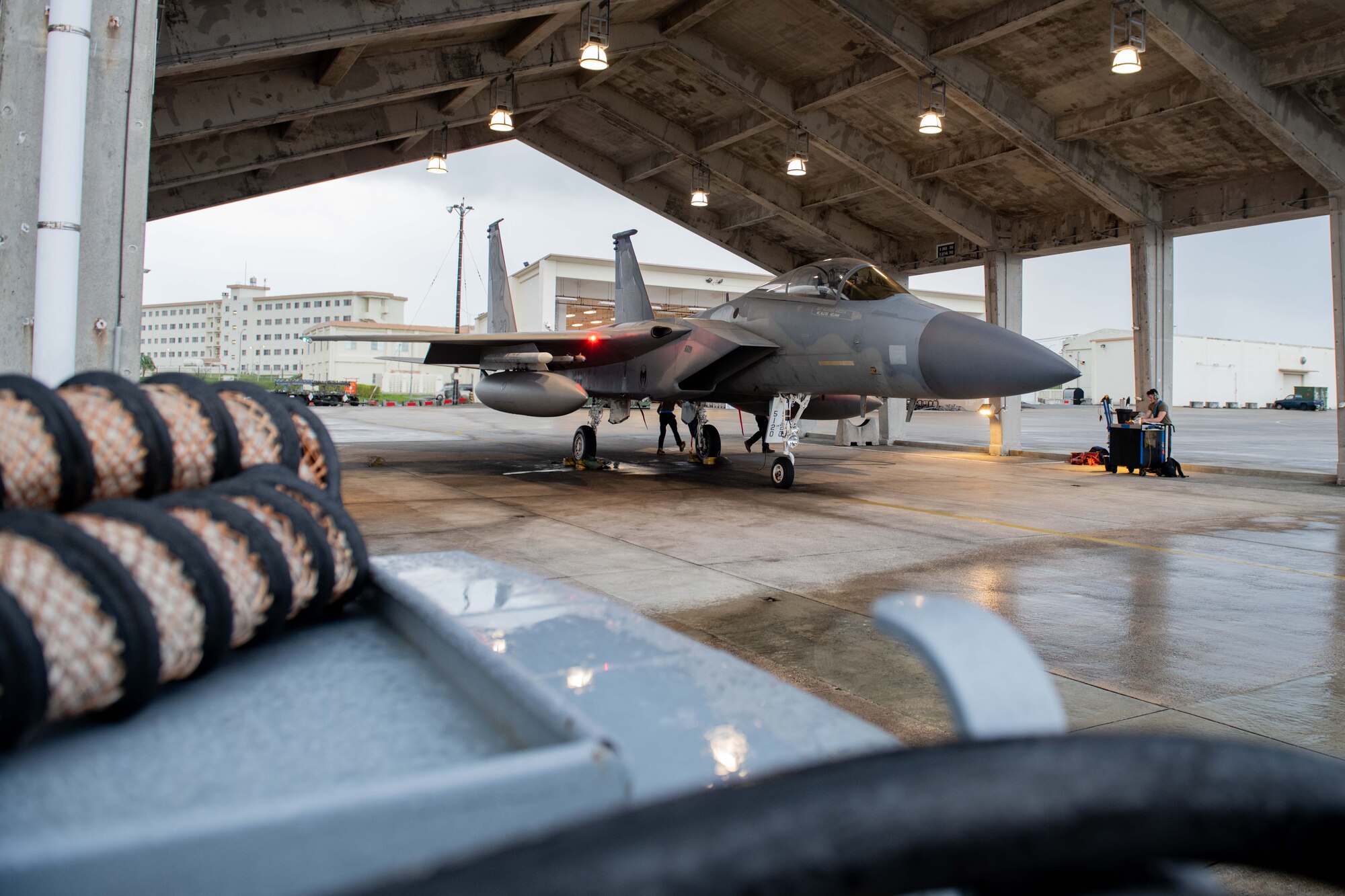 A fighter jet sits in a hangar