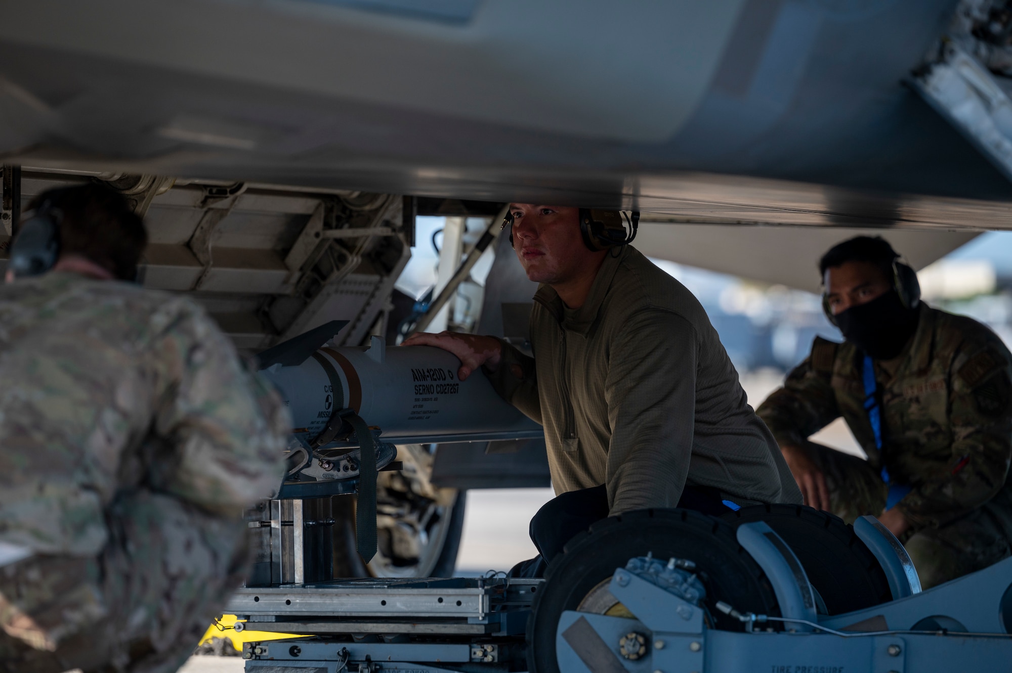 Airmen load a missile onto an aircraft