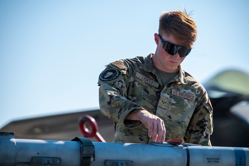 Airman secures a missile to a cart