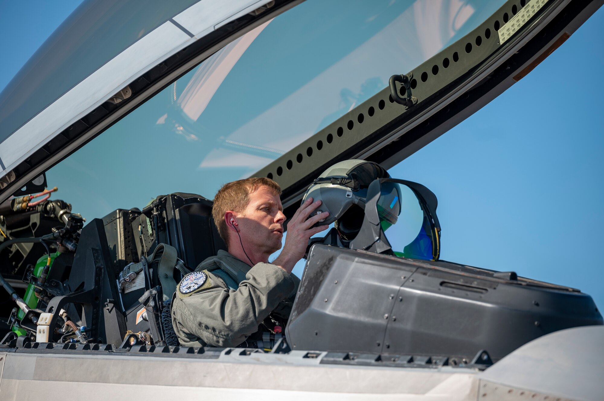 Pilot puts on a helmet