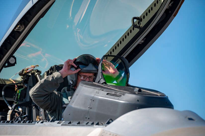 Pilot puts on a helmet